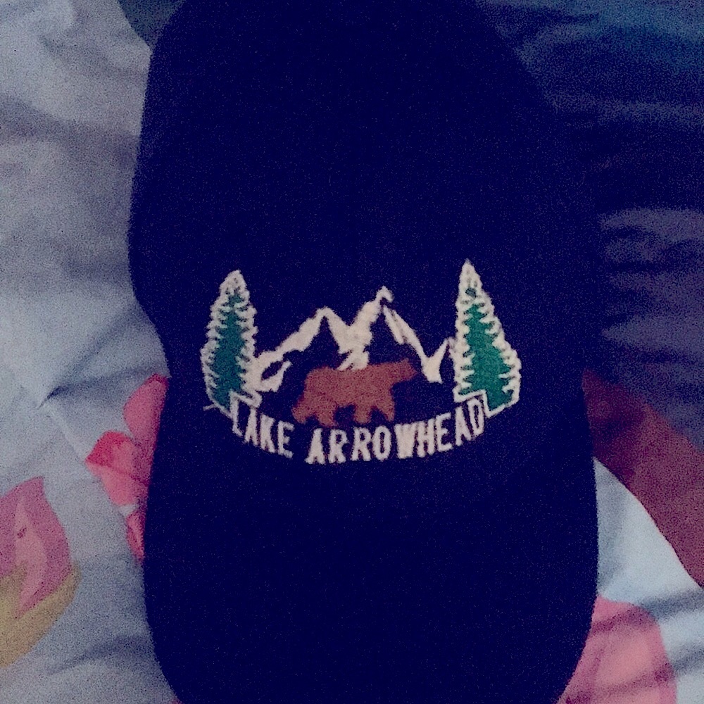 Adjustable blue Lake Arrowhead cap.